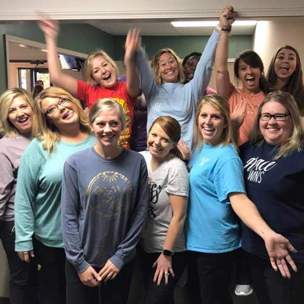 Team at Premier Dental Center posing for a funny picture