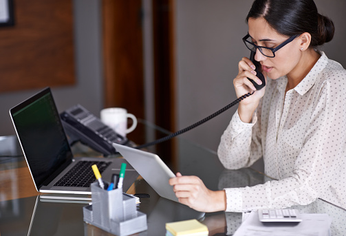 Receptionist answering the phone. 