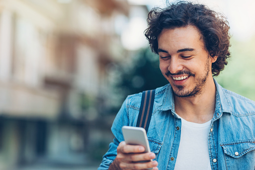 Man smiling at his phone. 