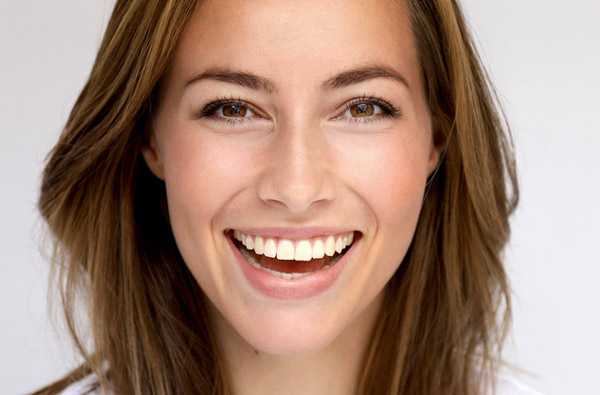 Beautiful woman smiling after receiving cosmetic dentistry treatment at Premier Dental Center Beautiful woman smiling after receiving cosmetic dentistry treatment at Premier Dental Center