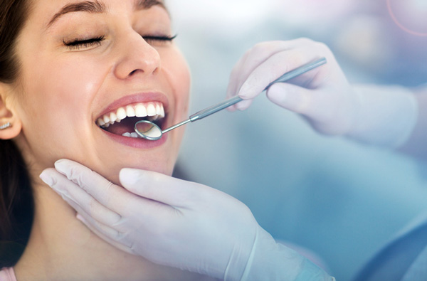 Woman getting dental exam at Premier Dental Center.