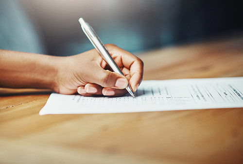 Patient filling out a form from Premier Dental 